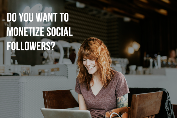 red headed woman looking at her laptop in a restaurant with the words "Do you want to monetize social followers"